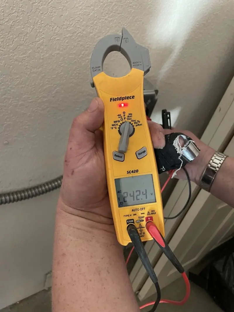 Voltage testing with clamp meter during Outlet Installation in Sandy Oaks